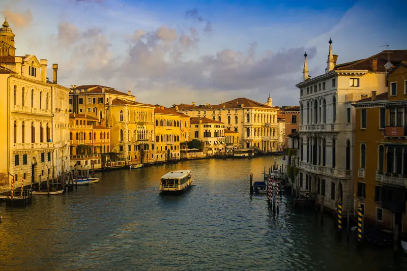 The Grand Canal, Venice in morning golden light with a vaporetto crossing.