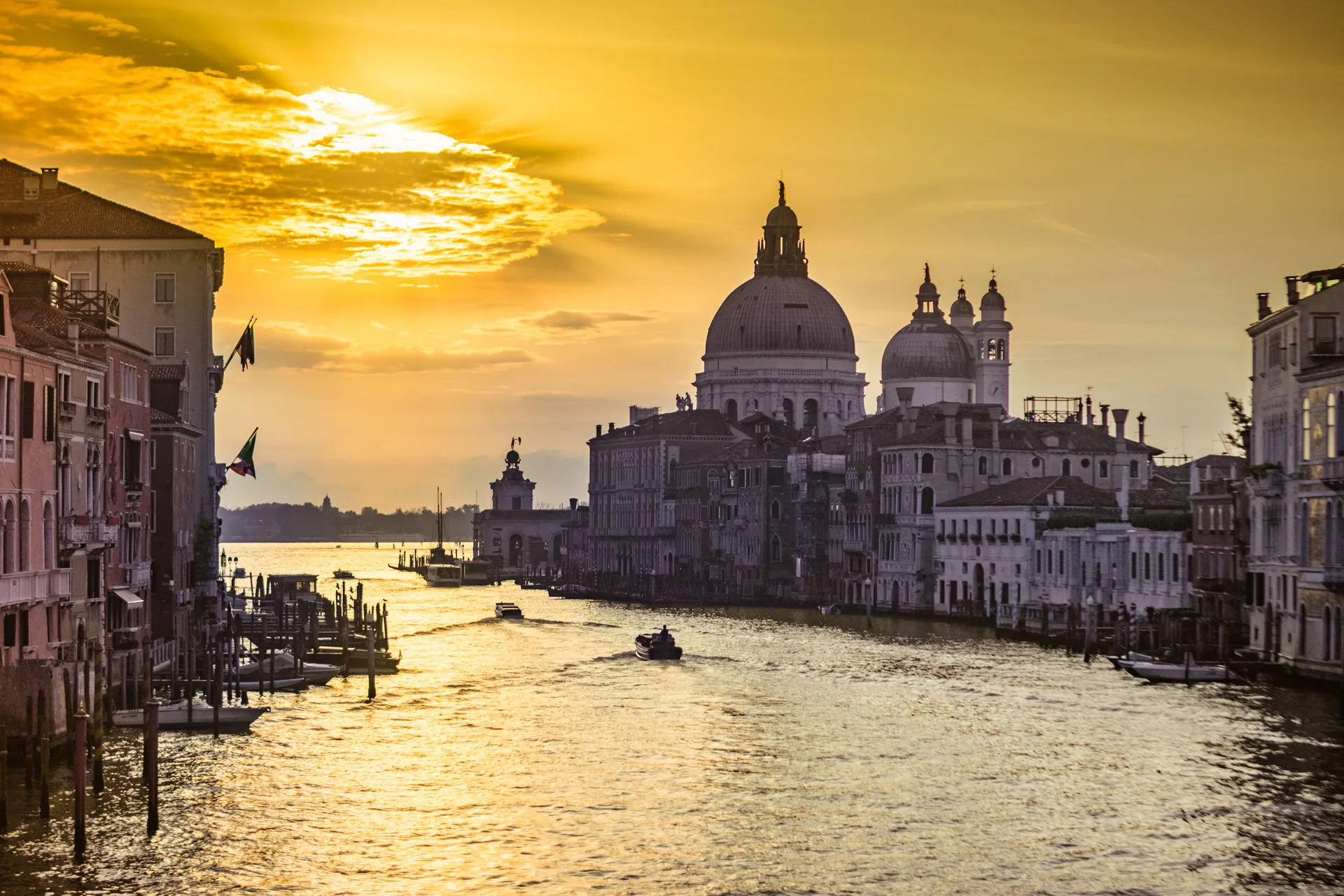 The Grand Canal at dawn, Venice. La Salute rises from the water under a golden sky.